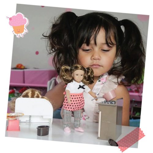 Girl with mini doll and play kitchen.