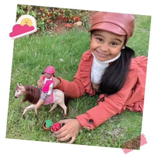 Girl with mini equestrian doll.