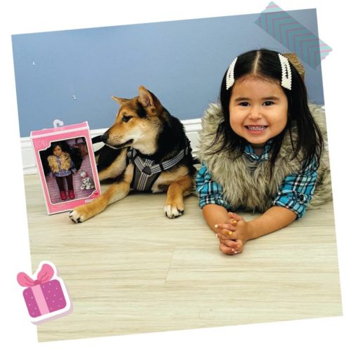 Girl with a mini doll and a dog.