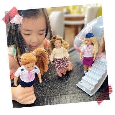 Girl playing with dolls.