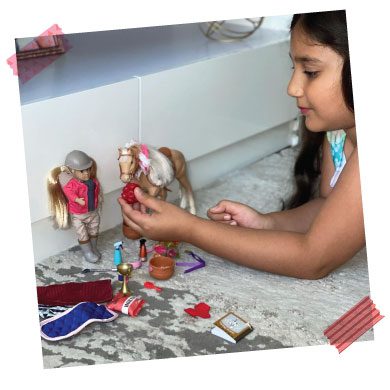 Girl playing with dolls.