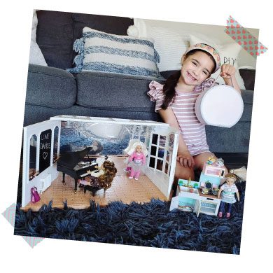 Girl playing with dolls.