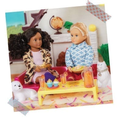 Two dolls drinking lemonade and eating pie.