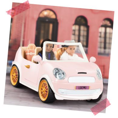 Mini dolls in a convertible car.