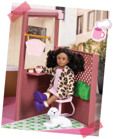 Mini doll sitting in a toy coffee shop.