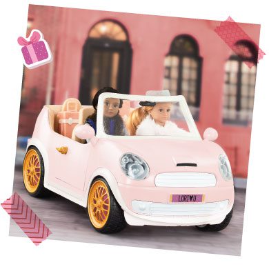 Two mini dolls in a car.