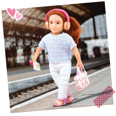 Mini doll at a train station.