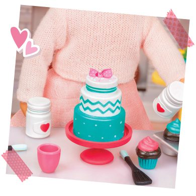 Mini doll with cake and baking accessories.