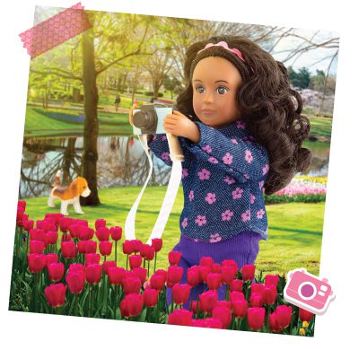 Mini doll photographing flowers.